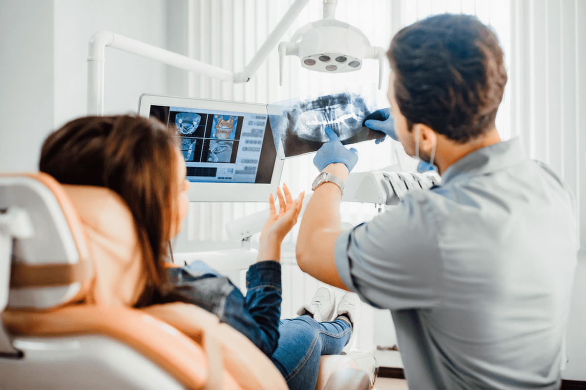 Dentist reviewing x-ray with patient